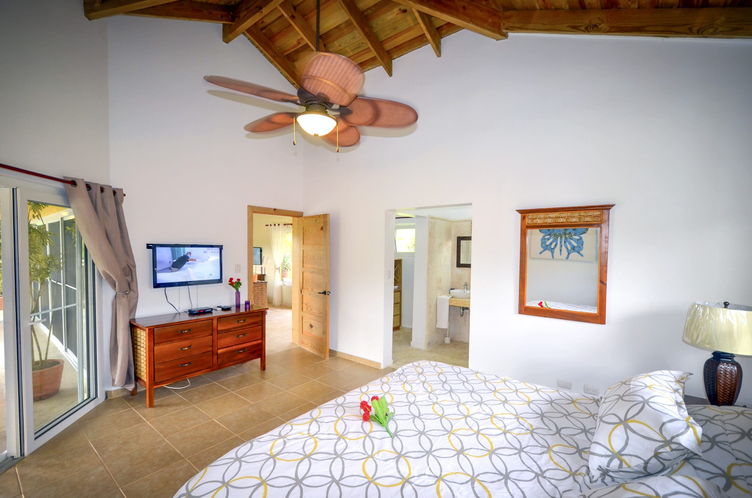 buyDRproperty Bedroom in a Villa For Sale in the Community of Terramar featuring a ceiling fan, TV, and a view. Sosua Real Estate