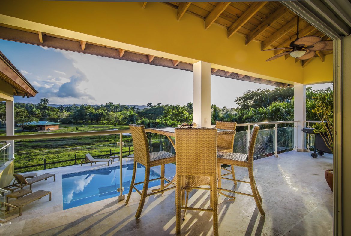 buyDRproperty Patio of a Villa For Sale in the Community of Terramar, with a pool and scenic view. Sosua Real Estate