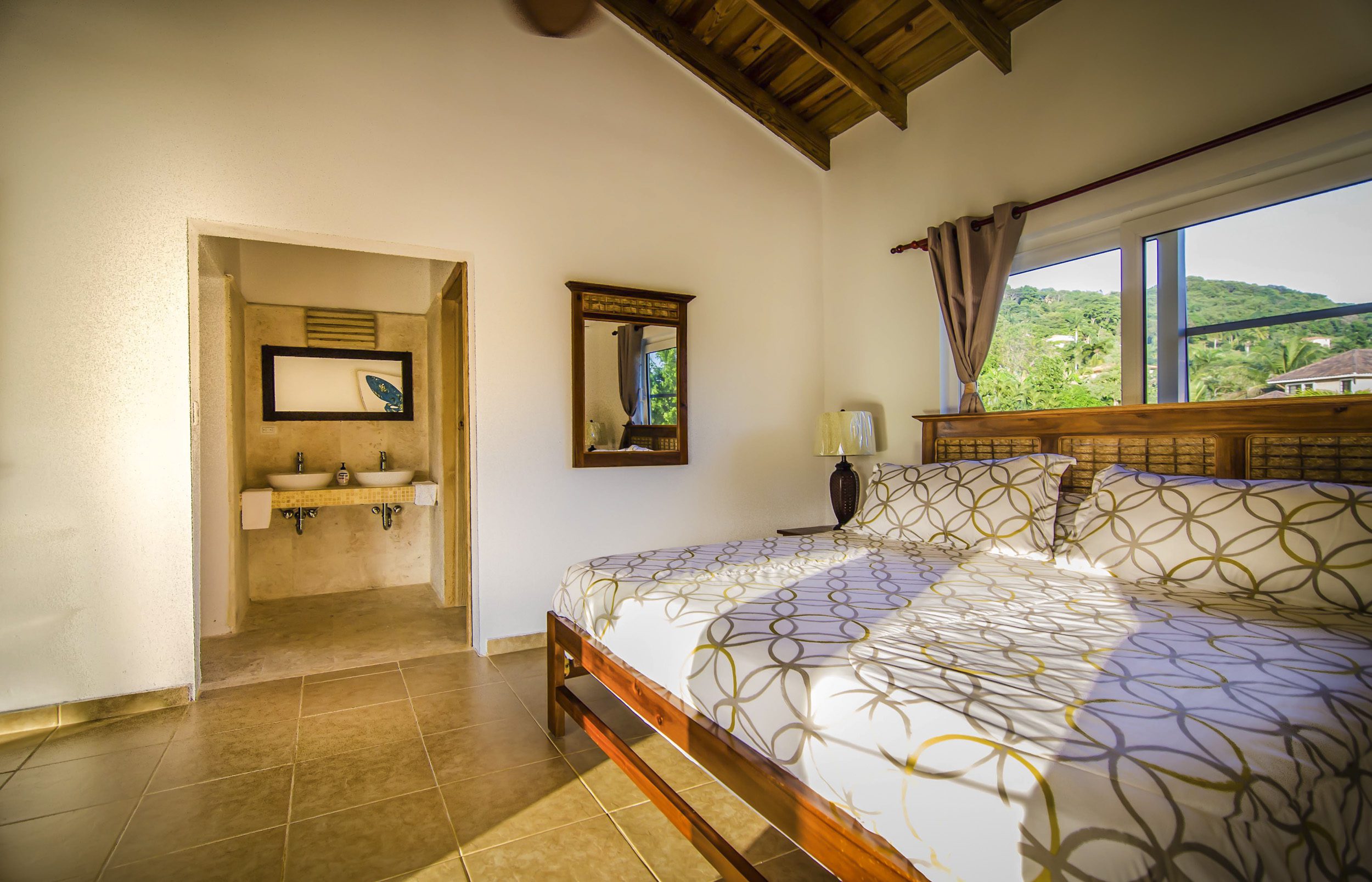 buyDRproperty Bedroom in a Villa For Sale in the Community of Terramar, featuring a bed and a view. Sosua Real Estate