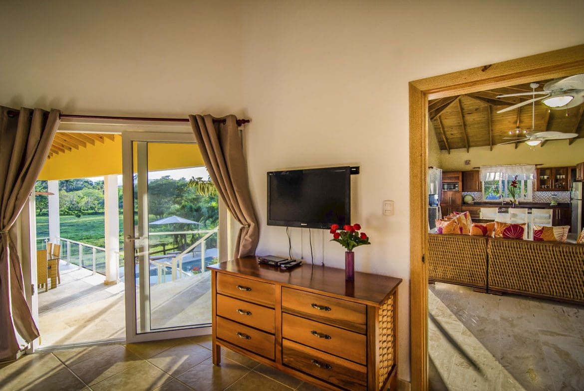 buyDRproperty Living room with TV, dresser, and view of the pool in a villa for sale in Terramar community. Sosua Real Estate