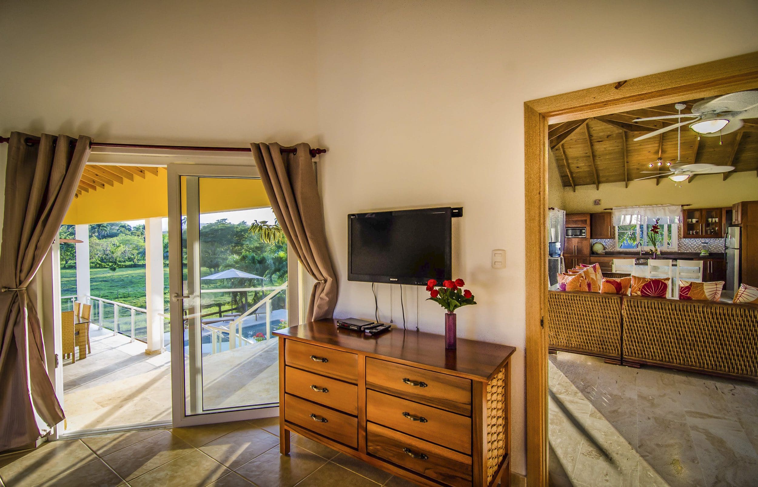 buyDRproperty Living room with TV, dresser, and view of the pool in a villa for sale in Terramar community. Sosua Real Estate