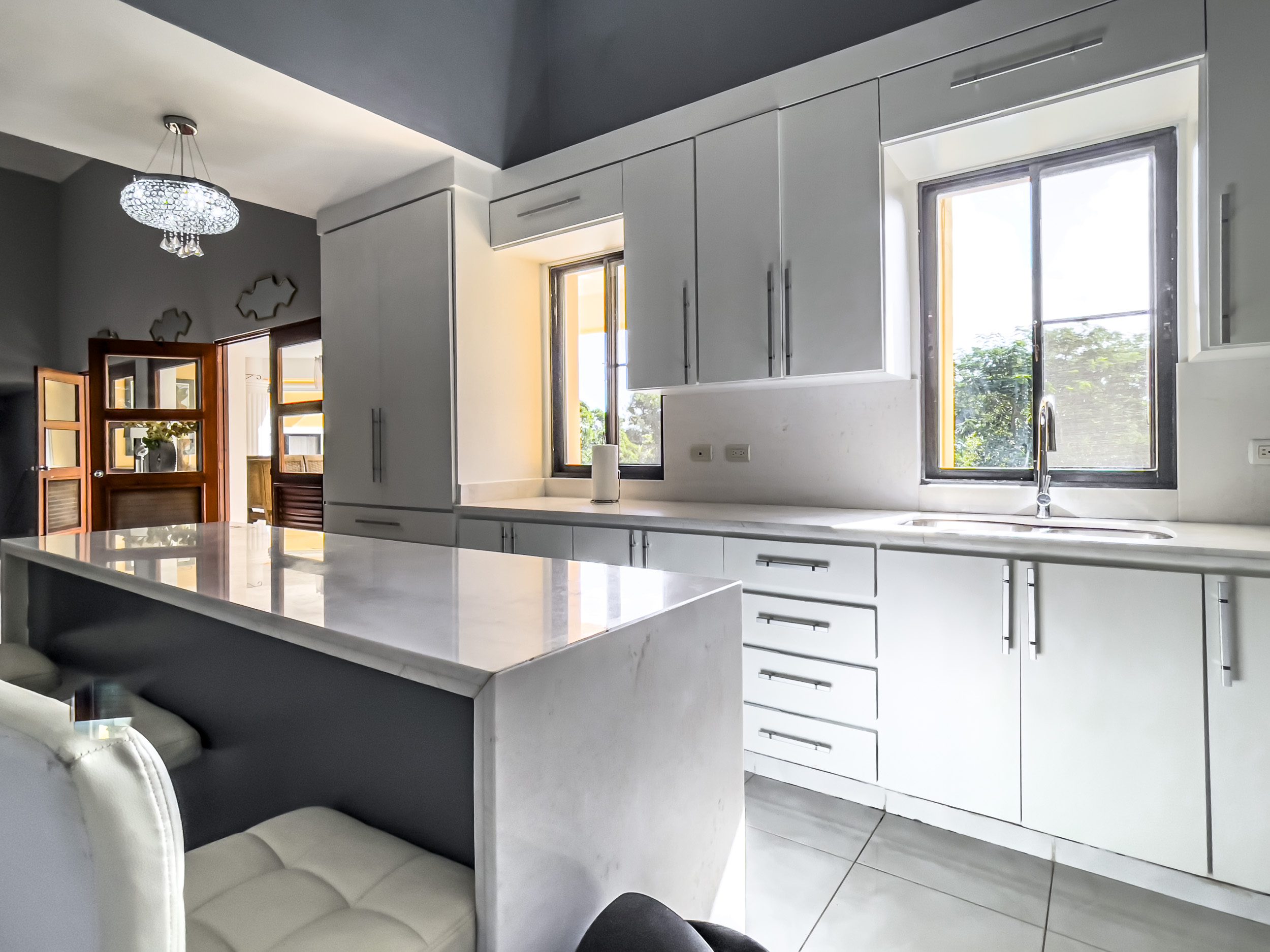 buyDRproperty Modern white kitchen in a stunning 4 bedroom villa with marble countertops. Sosua Real Estate
