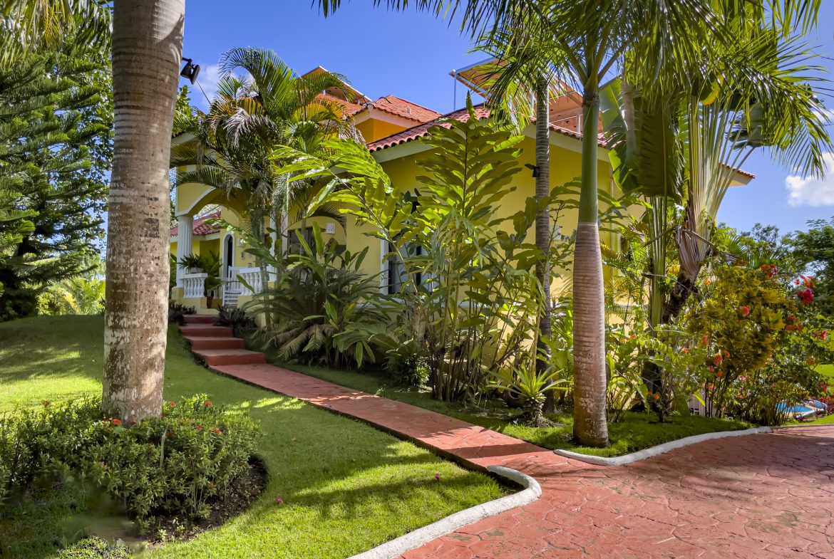 buyDRproperty Stunning 4 Bedroom Villa with tropical landscaping and red pathway Sosua Real Estate