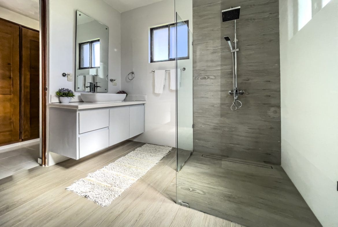 buyDRproperty Modern bathroom with walk-in shower and wood-look tiles in a stunning 4 bedroom villa. Sosua Real Estate