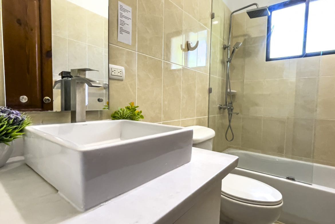 buyDRproperty Modern bathroom with white sink and shower in a stunning 4 bedroom villa. Sosua Real Estate