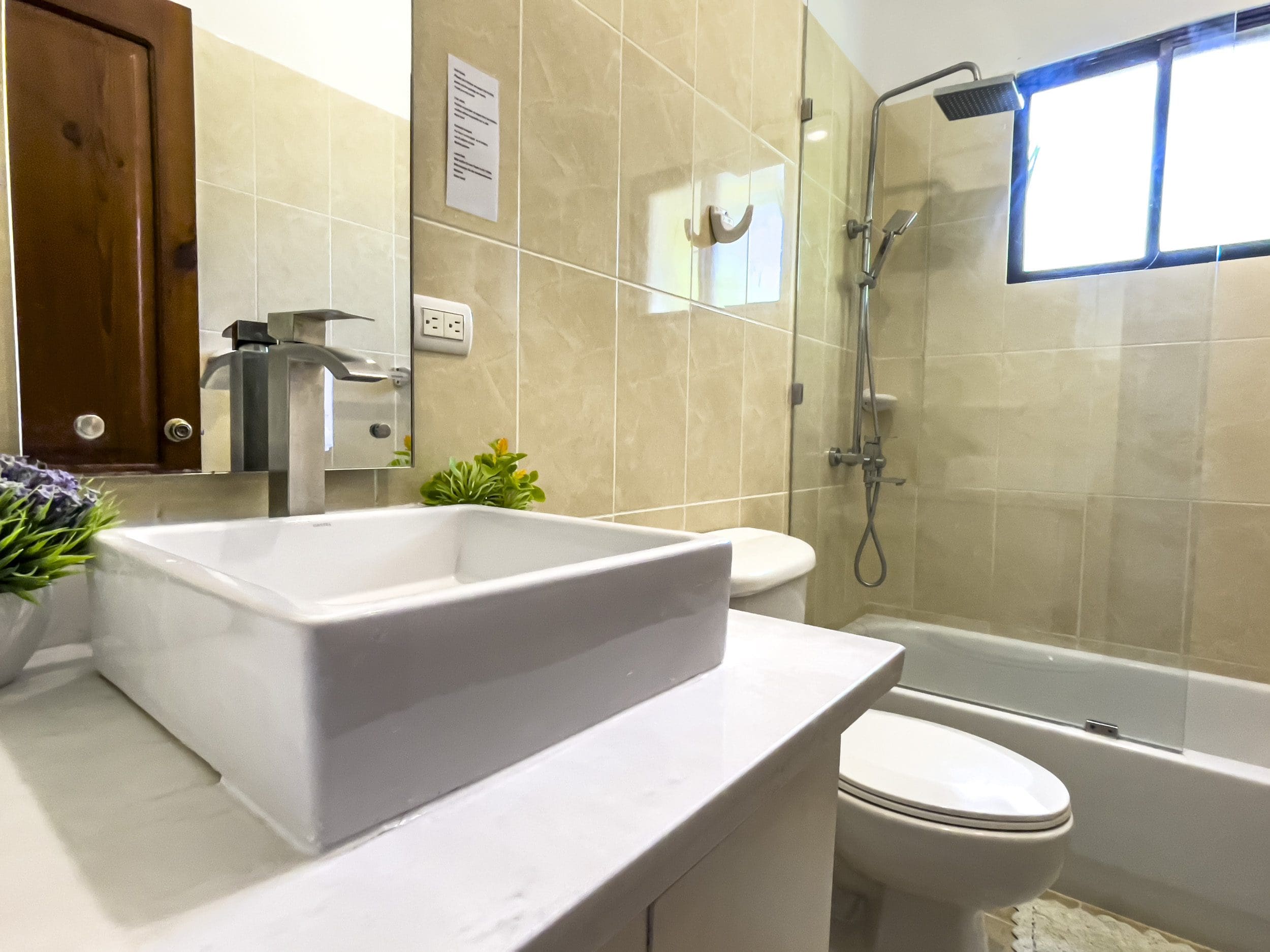 buyDRproperty Modern bathroom with white sink and shower in a stunning 4 bedroom villa. Sosua Real Estate