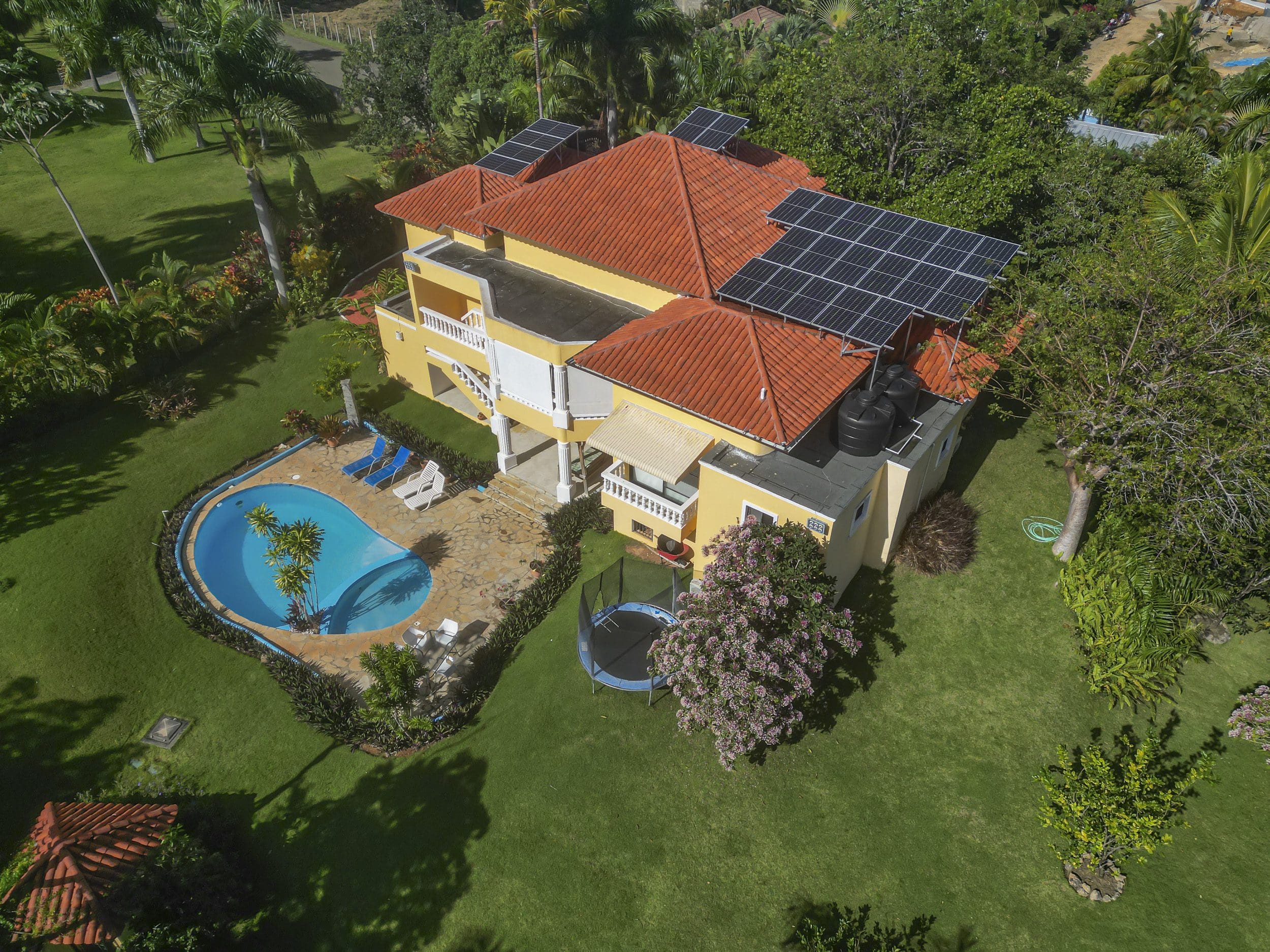 buyDRproperty Aerial view of a stunning 4 bedroom villa with a pool and solar panels Sosua Real Estate