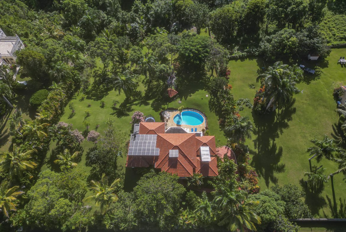 buyDRproperty Stunning 4 Bedroom Villa for sale in Panorama Village, featuring a pool and lush landscaping. Sosua Real Estate
