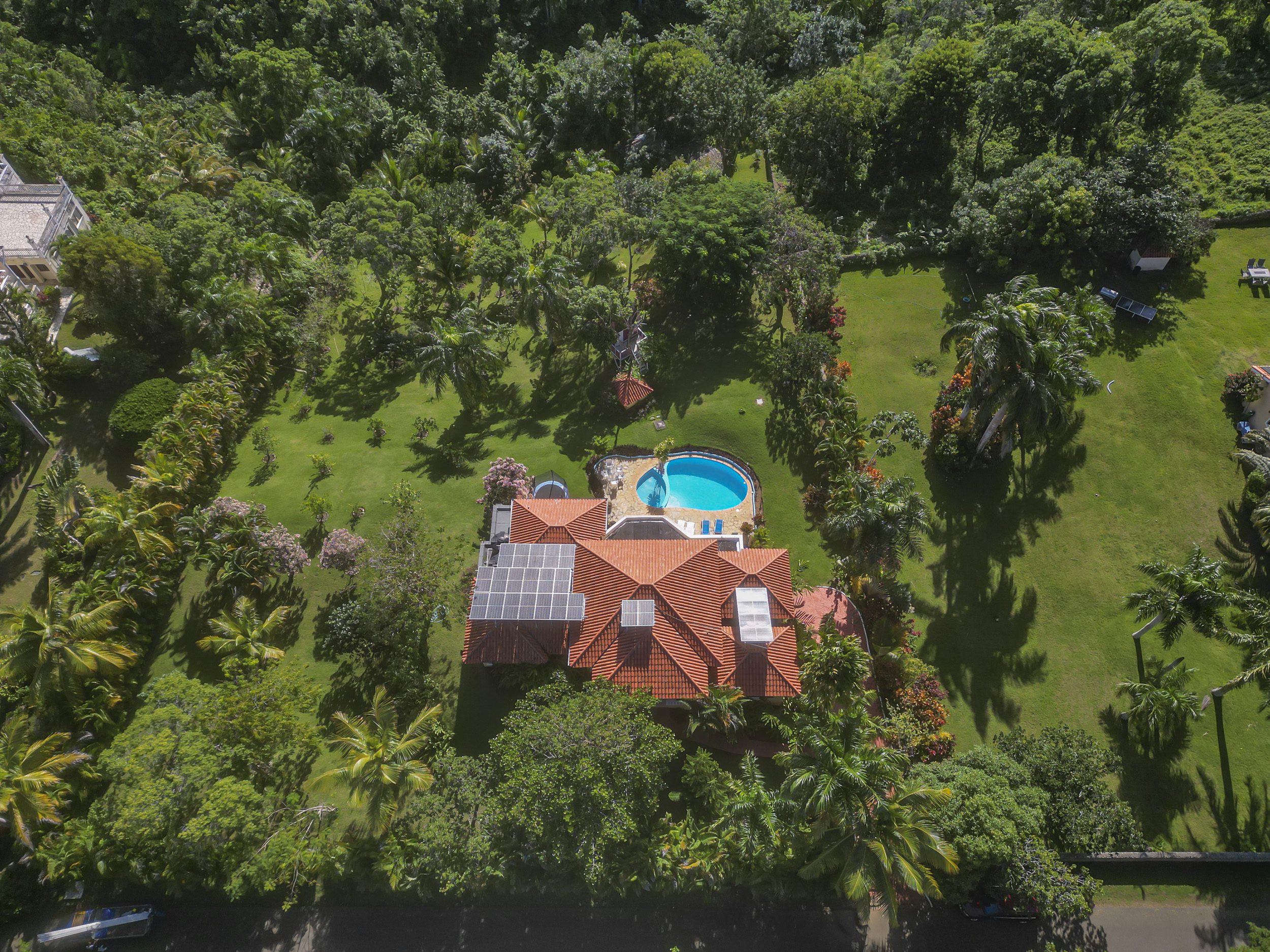 buyDRproperty Stunning 4 Bedroom Villa for sale in Panorama Village, featuring a pool and lush landscaping. Sosua Real Estate