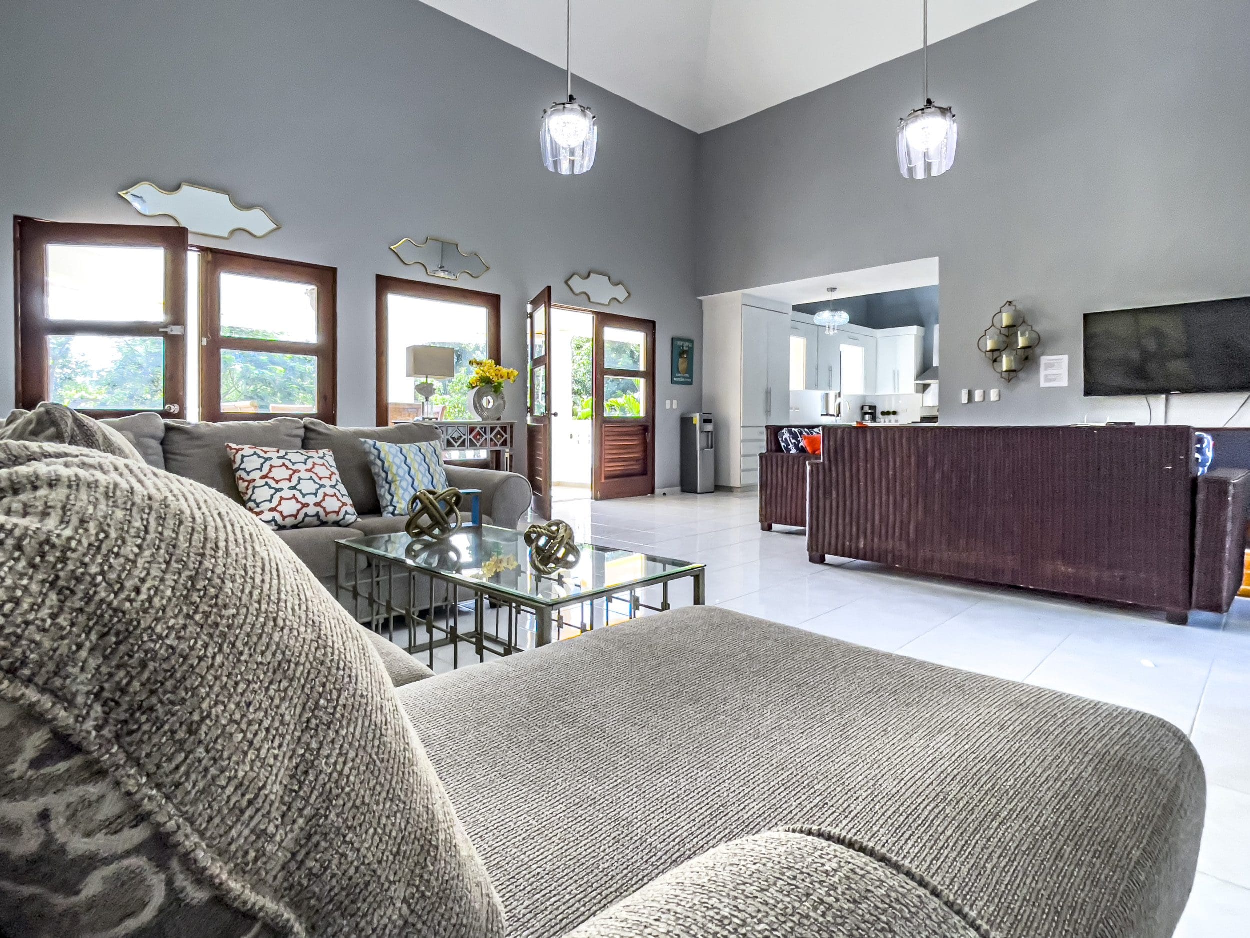 buyDRproperty Living room of a stunning 4 bedroom villa with a large sofa and glass coffee table Sosua Real Estate
