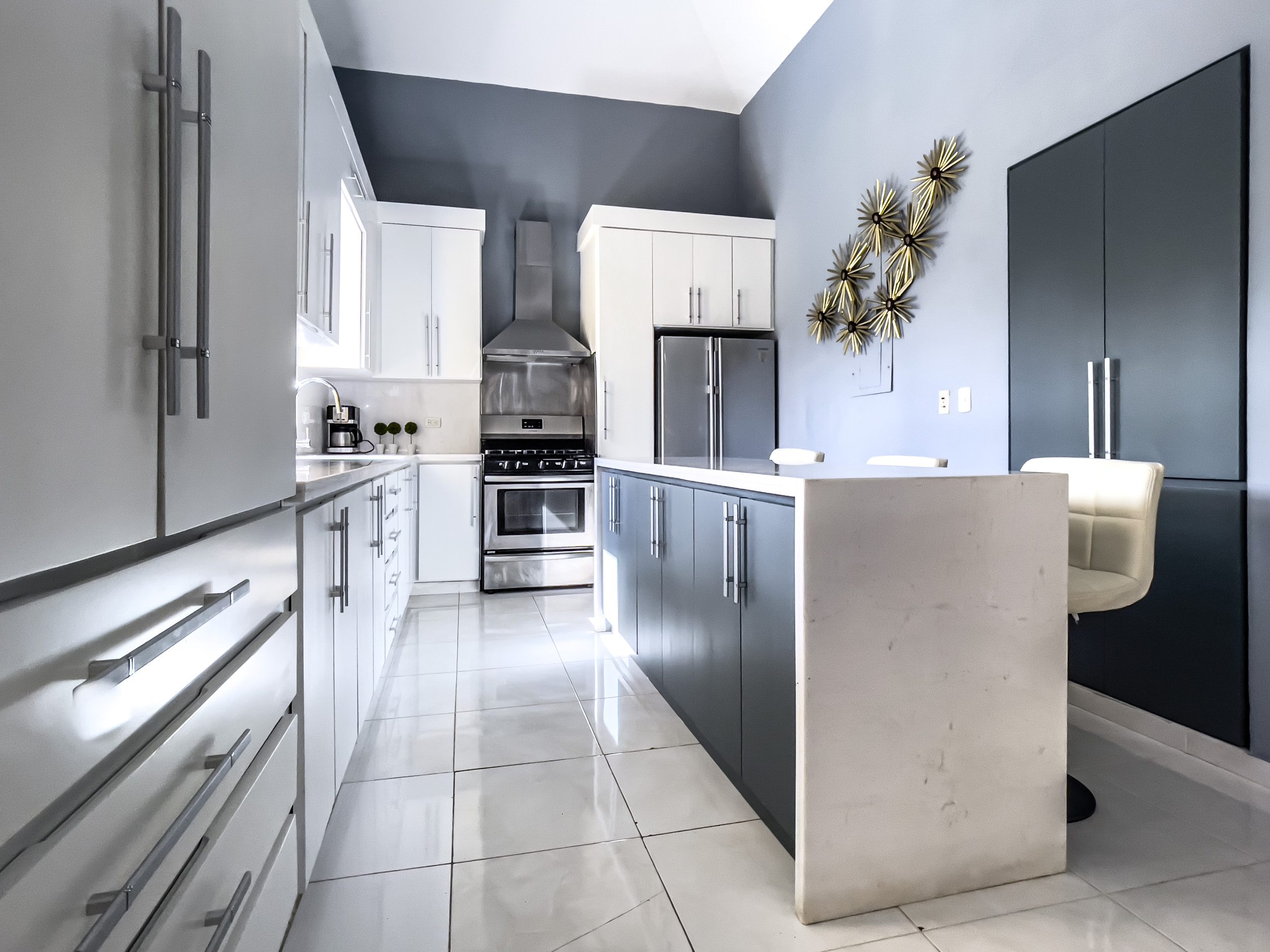 buyDRproperty Modern kitchen in a stunning 4 bedroom villa with white cabinets and stainless steel appliances. Sosua Real Estate