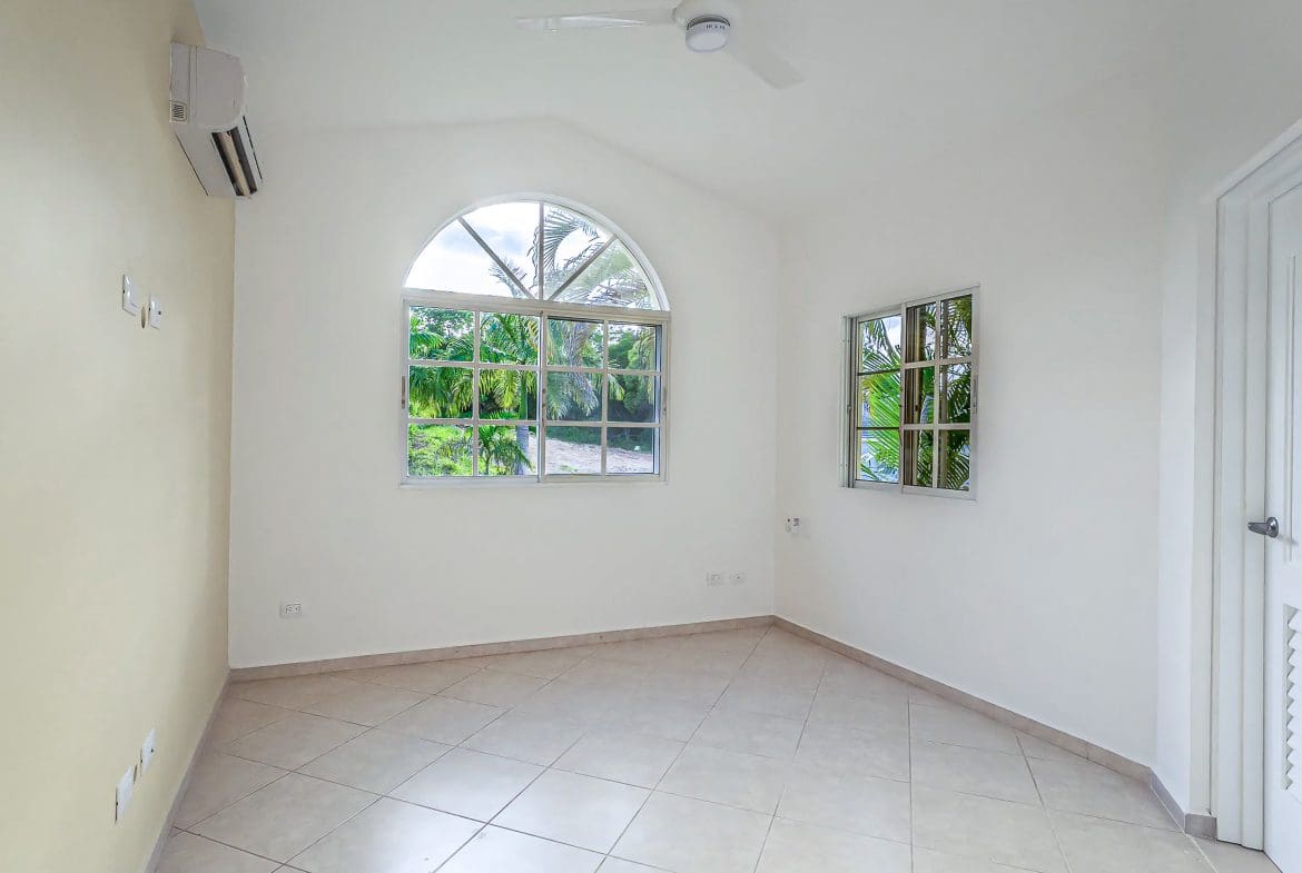 buyDRproperty Bright, empty room with arched window, part of the Renovated Villa CAOBA in Residencial Hispaniola. Sosua Real Estate
