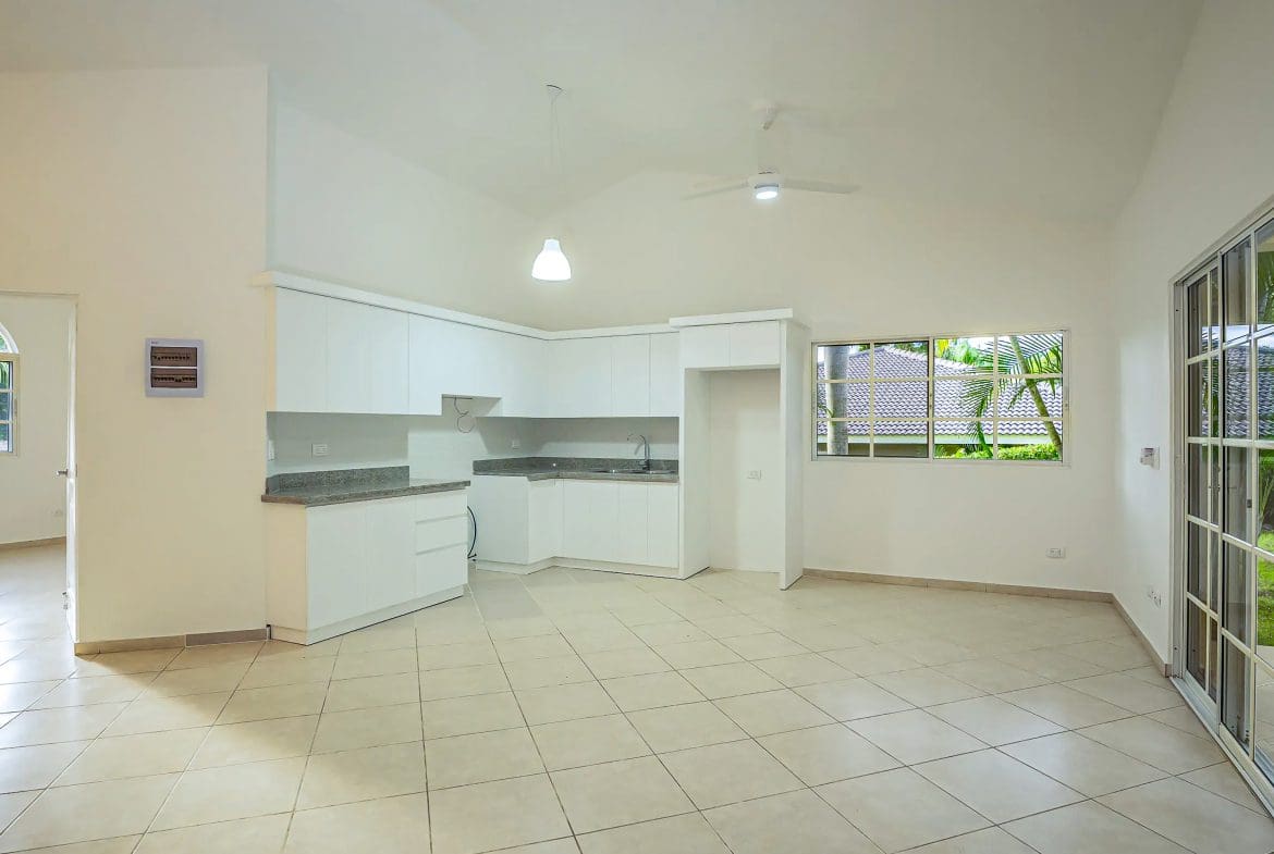 buyDRproperty Bright, renovated kitchen in Villa CAOBA with white cabinets and granite countertops. Sosua Real Estate