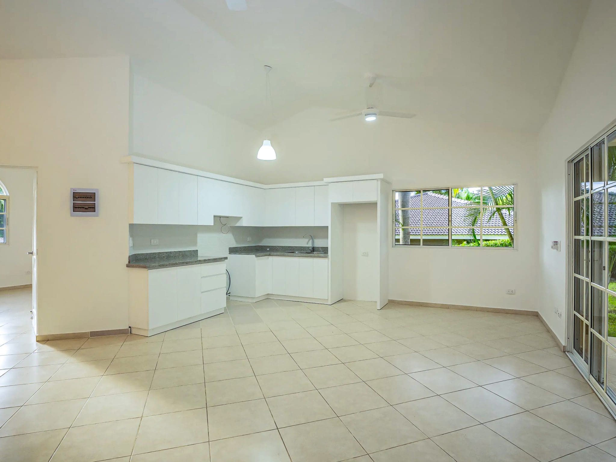 buyDRproperty Bright, renovated kitchen in Villa CAOBA with white cabinets and granite countertops. Sosua Real Estate