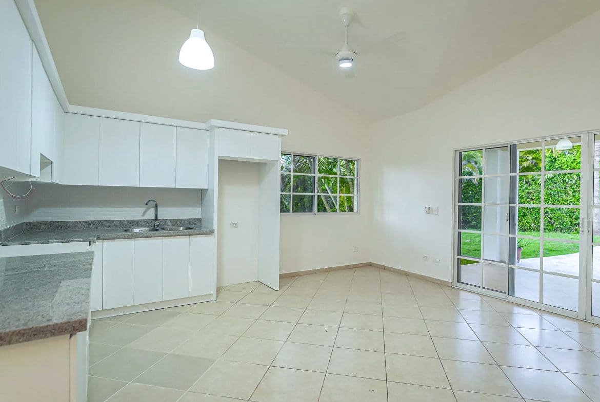 buyDRproperty Bright, modern kitchen in a Renovated Villa CAOBA with white cabinets and tile floors Sosua Real Estate
