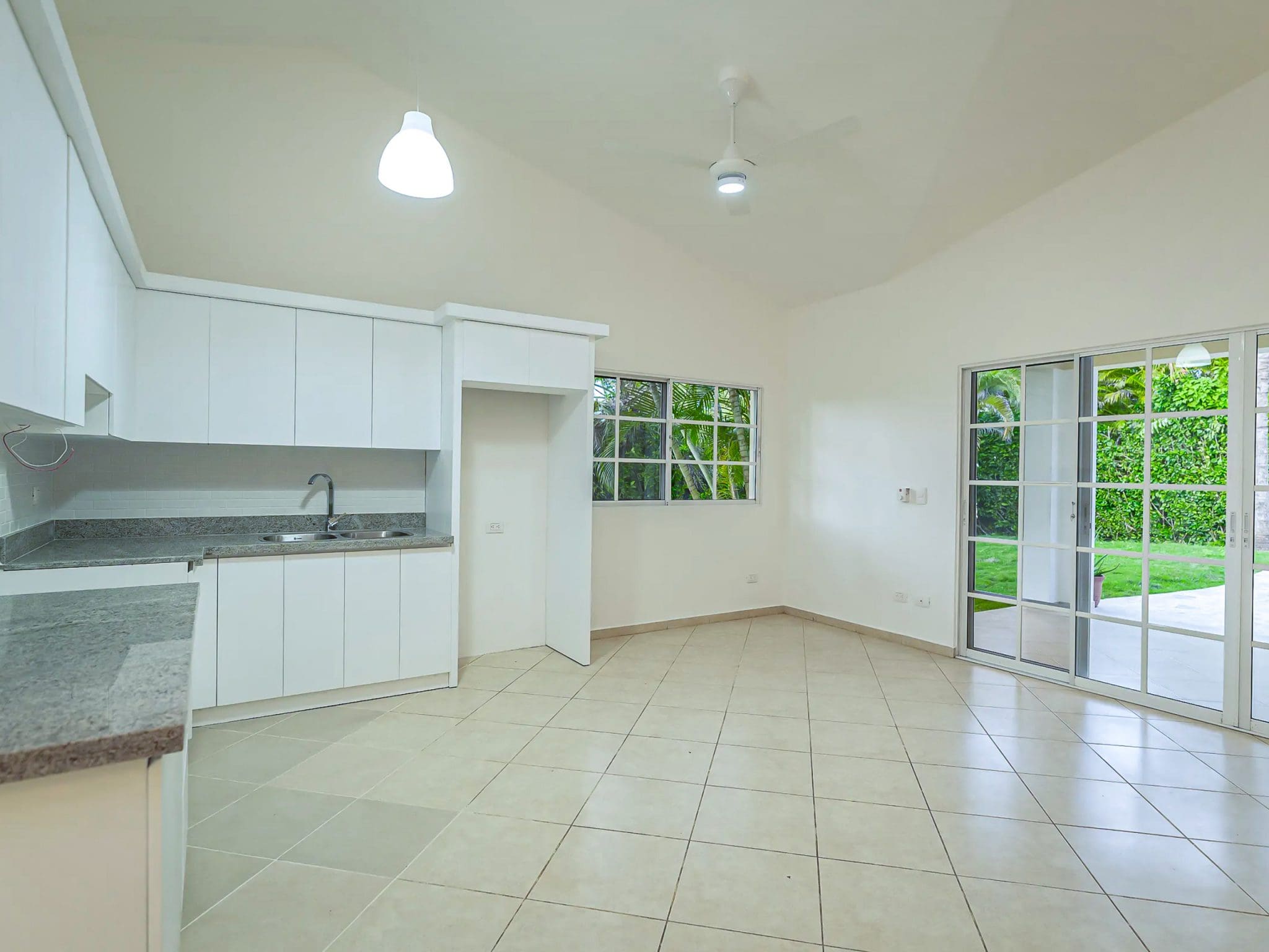 buyDRproperty Bright, modern kitchen in a Renovated Villa CAOBA with white cabinets and tile floors Sosua Real Estate