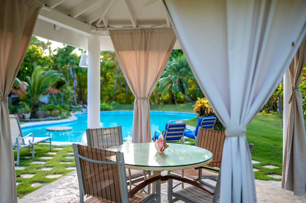 buyDRproperty Sea Horse Ranch Villa Luna outdoor dining area with pool view. Sosua Real Estate