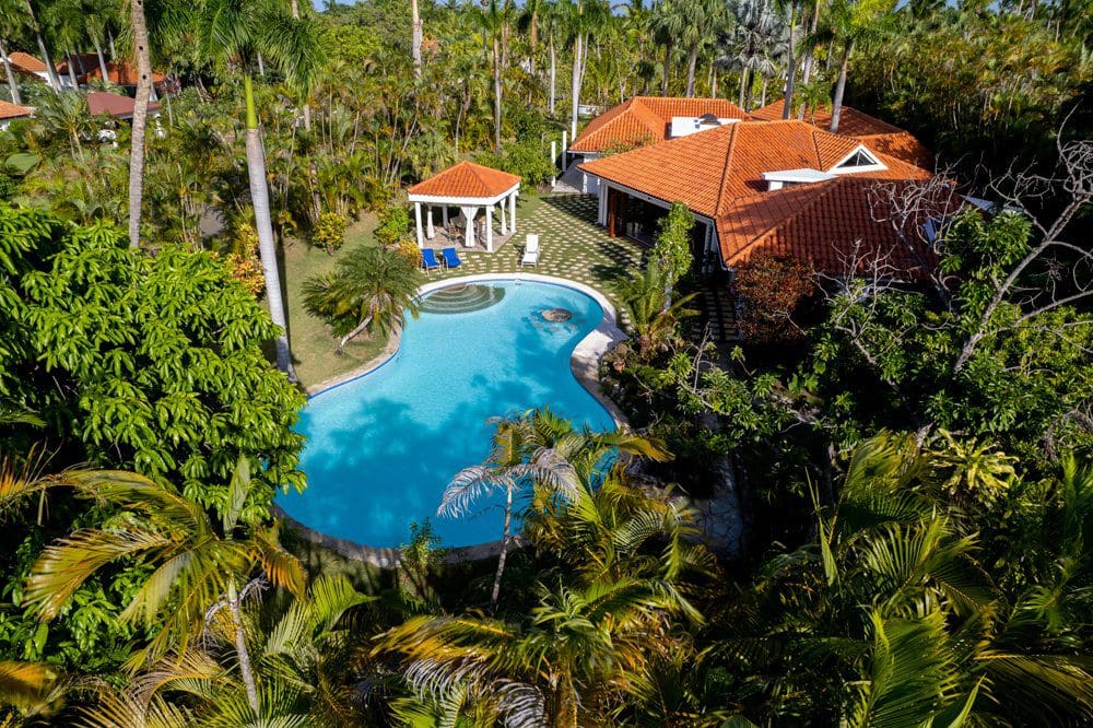buyDRproperty Villa LUNA oceanfront property with pool and gazebo surrounded by lush greenery at Sea Horse Ranch. Sosua Real Estate