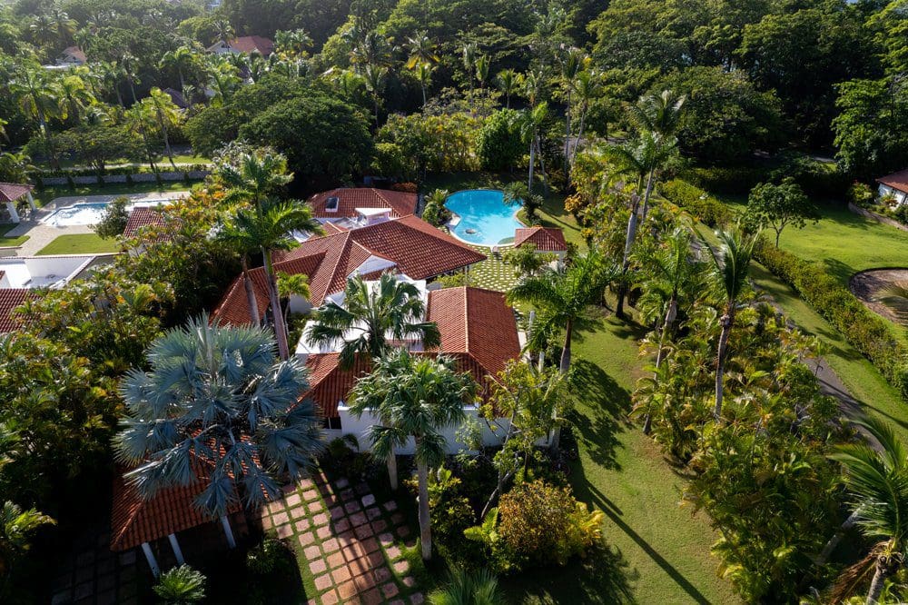 buyDRproperty Aerial view of Villa LUNA oceanfront property in Sea Horse Ranch, showcasing a luxury villa with a pool. Sosua Real Estate