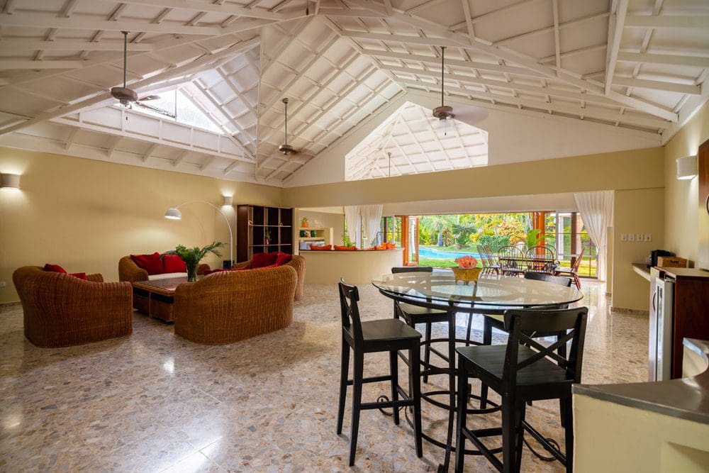 buyDRproperty Spacious interior of a villa luna with wicker furniture and a view of the Sea Horse Ranch. Sosua Real Estate
