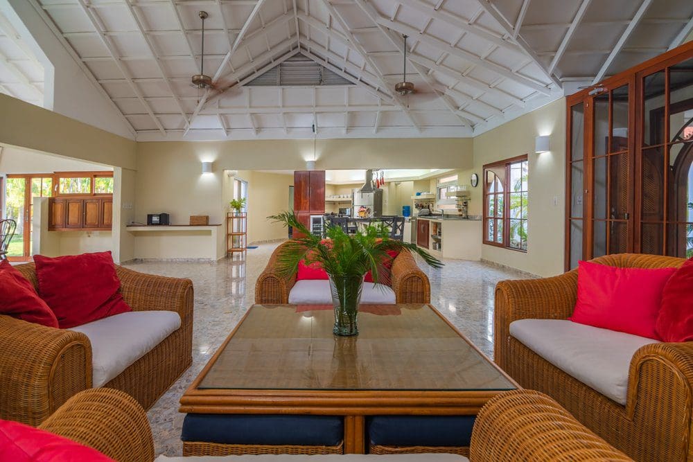 buyDRproperty Living room with rattan furniture in a Villa Luna oceanfront home. Sosua Real Estate