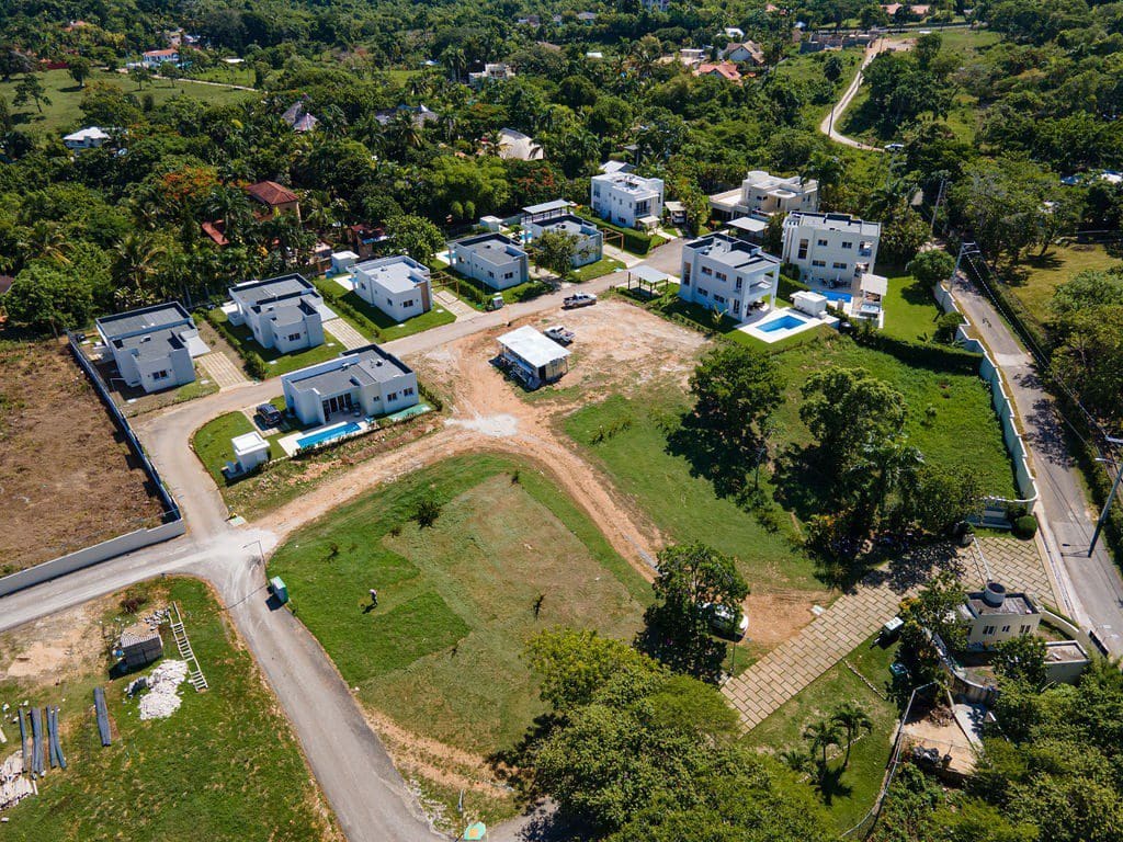buyDRproperty Aerial view of a modern Countryside Villa For Sale with a private pool in a lush green setting. Villas Tisú. Sosua Real Estate