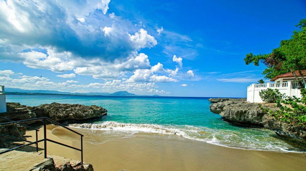 buyDRproperty Beachfront view of the ocean with a condo for sale close to the beach and blue sky Sosua Real Estate