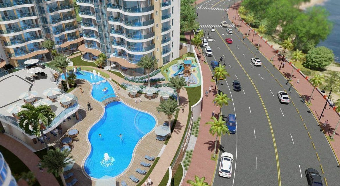 buyDRproperty Atlantic Luxury Towers condo complex in the Dominican Republic with pool and road. Sosua Real Estate