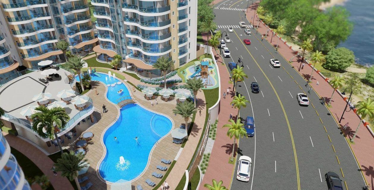 buyDRproperty Atlantic Luxury Towers condo complex in the Dominican Republic with pool and road. Sosua Real Estate