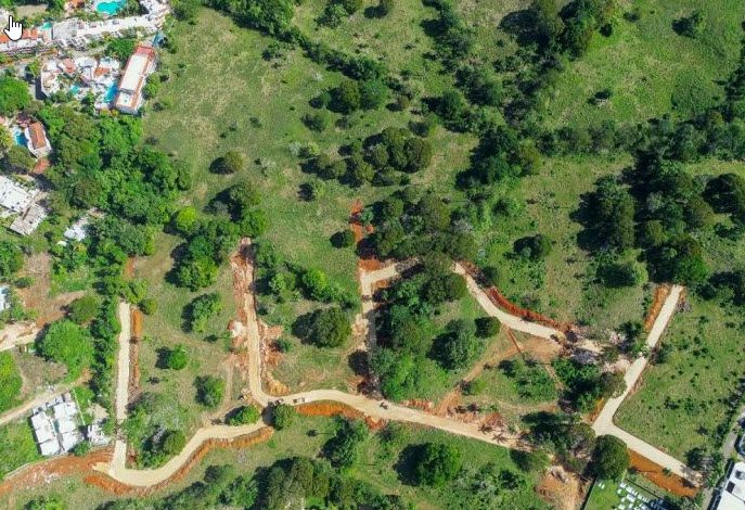 buyDRproperty Aerial view of beautiful building lots with cleared roads in a green landscape. Sosua Real Estate