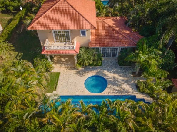 buyDRproperty Luxury Caribbean villa with private pool surrounded by palm trees. Sosua Real Estate