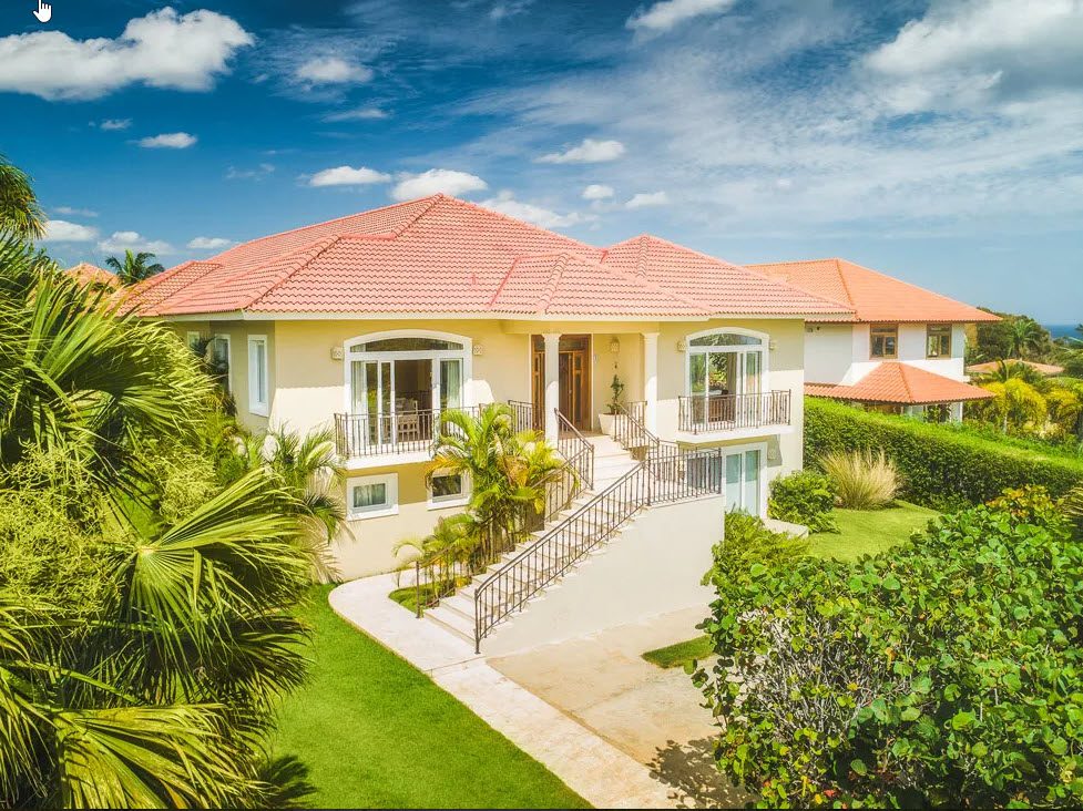 buyDRproperty Beautiful 5 Bedroom Villa in Sosua Residential Hispaniola with red tile roof and lush landscaping. Sosua Real Estate