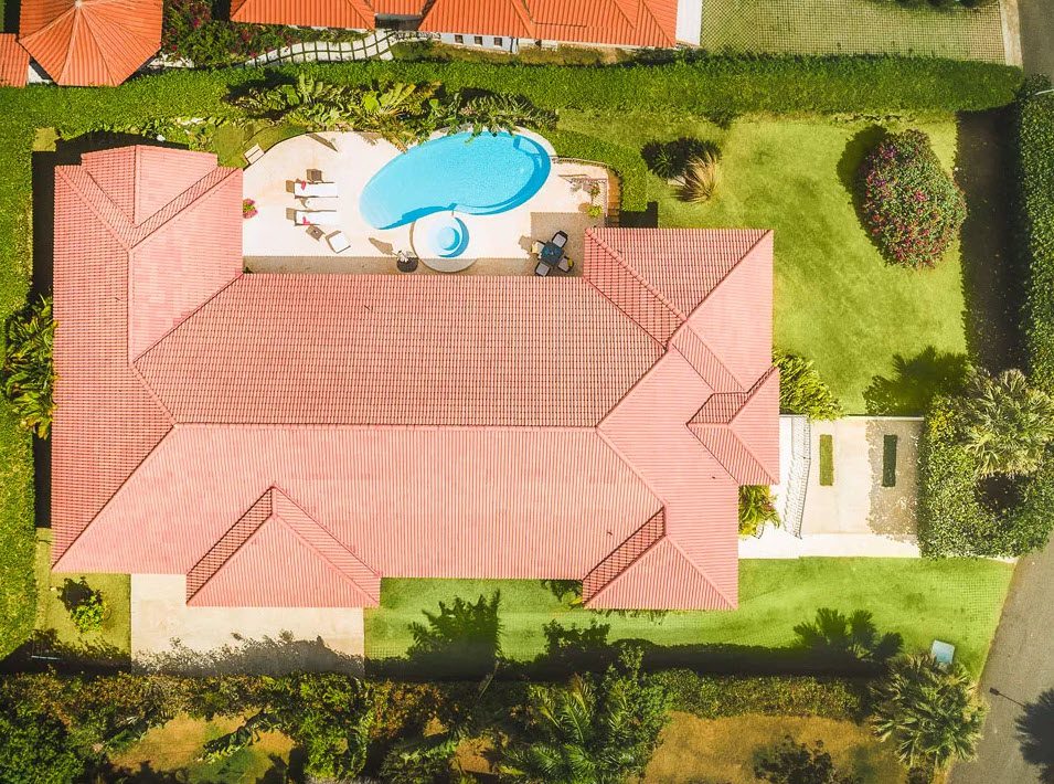 buyDRproperty Aerial view of a beautiful 5 bedroom villa in Residential Hispaniola with a pool and lush landscaping. Sosua Real Estate