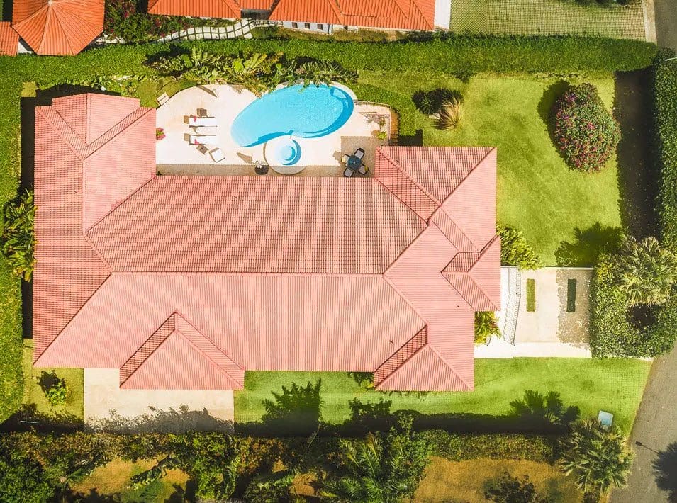 buyDRproperty Aerial view of a beautiful 5 bedroom villa in Residential Hispaniola with a pool and lush landscaping. Sosua Real Estate