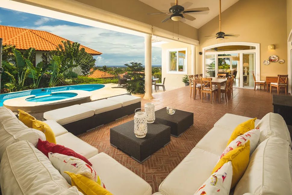 buyDRproperty Outdoor patio of a beautiful 5 bedroom villa in Sosua. Features a pool and seating area. Sosua Real Estate