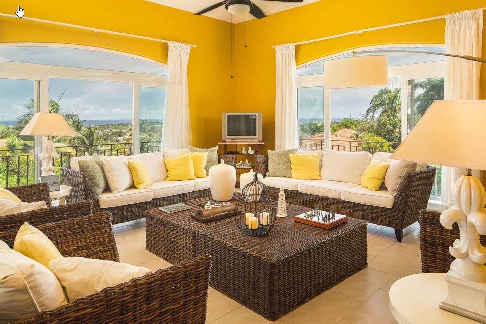 buyDRproperty Living room of a beautiful 5 bedroom villa in Residential Hispaniola with wicker furniture. Sosua Real Estate