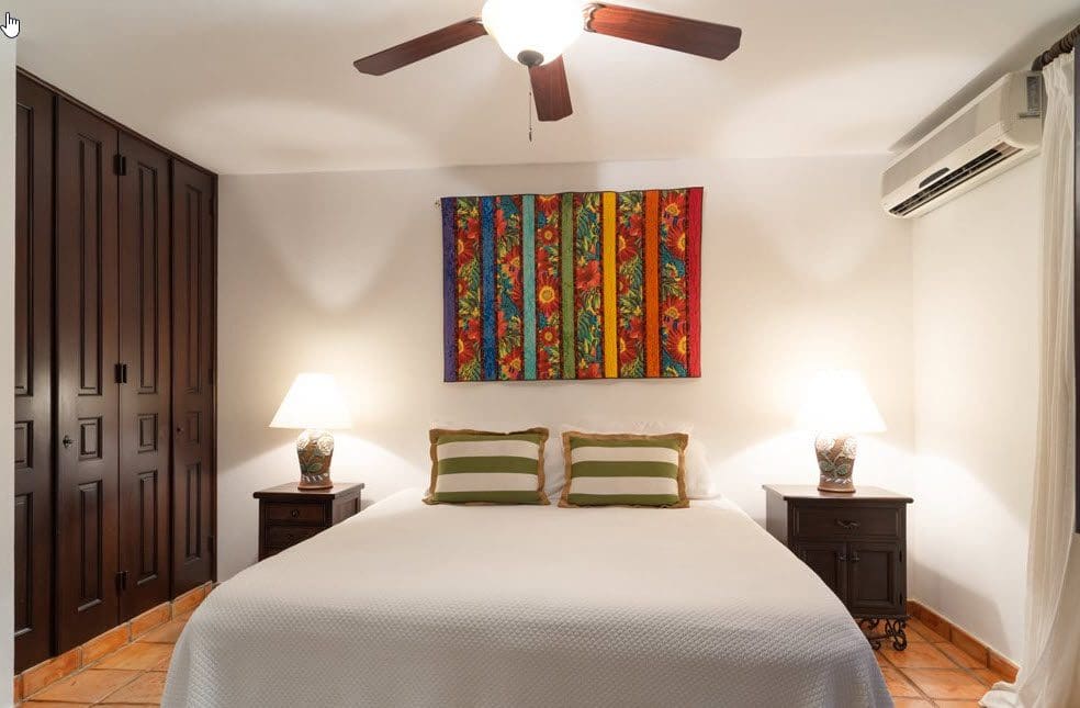 buyDRproperty Bedroom in a Stunning Oceanfront Villa with colorful wall art. Sosua Real Estate