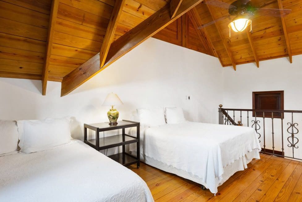 buyDRproperty Bedroom in stunning oceanfront villa with wood ceiling and two beds. Sosua Real Estate