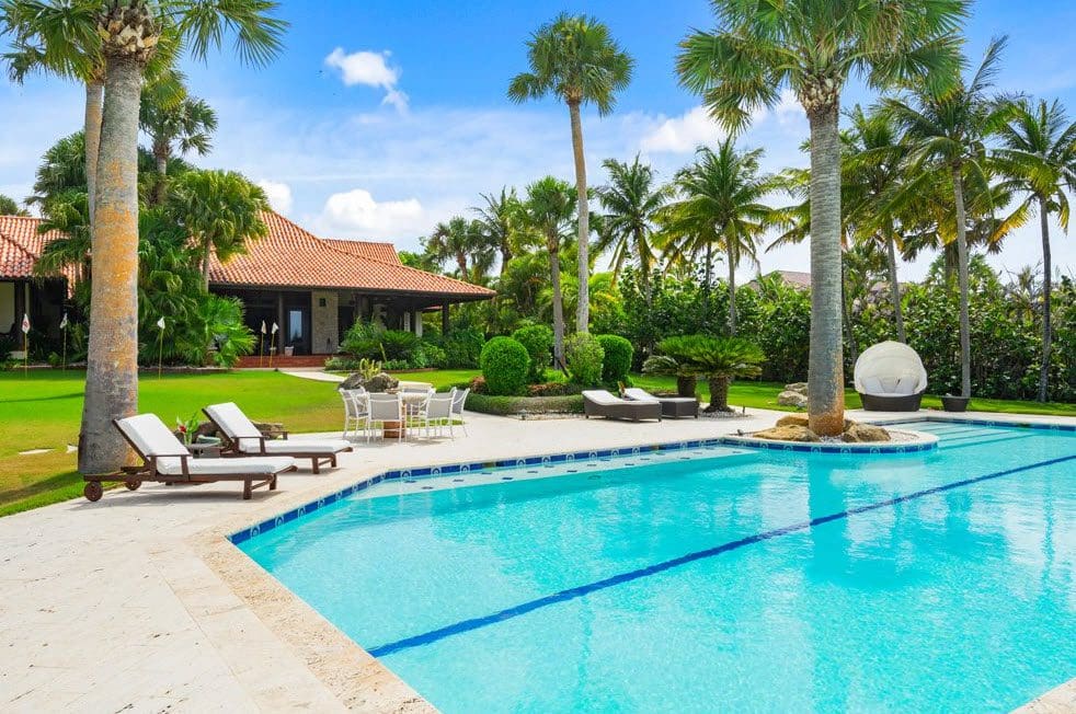 buyDRproperty Stunning Oceanfront Villa with a swimming pool and palm trees at Sea Horse Ranch. Sosua Real Estate