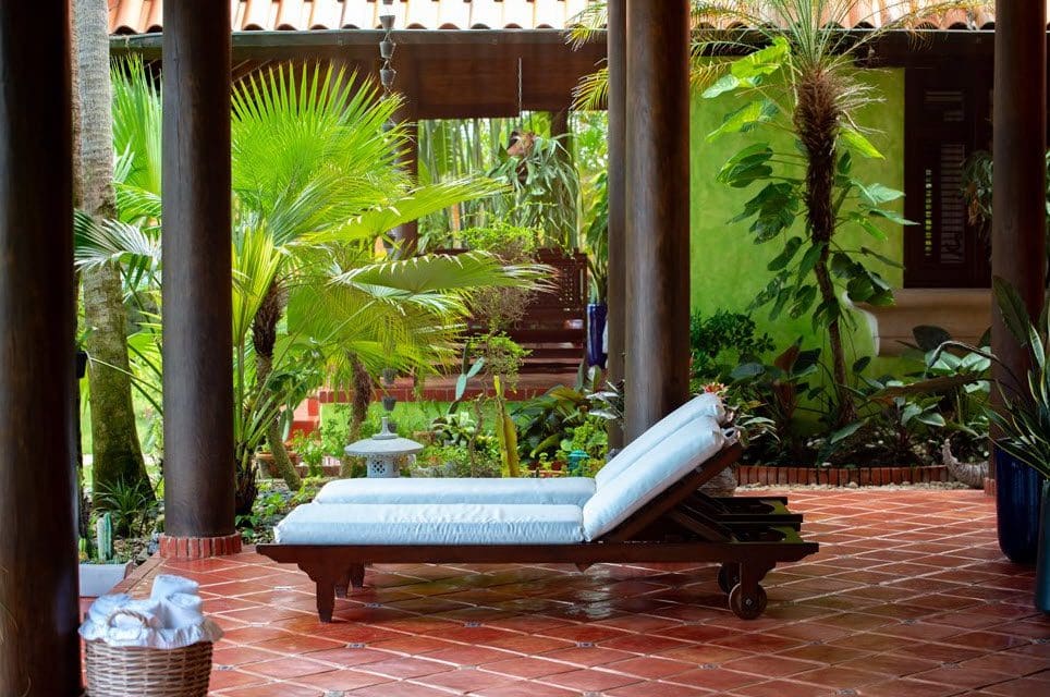 buyDRproperty Lounge chair on the patio of a stunning oceanfront villa in the Dominican Republic, Sea Horse Ranch. Sosua Real Estate