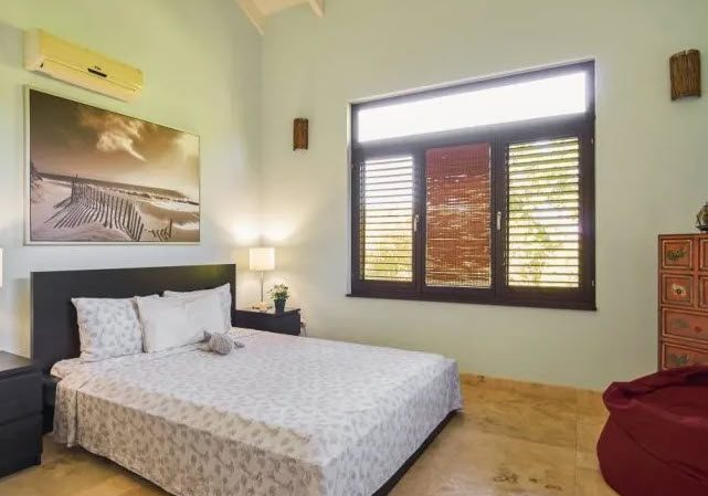 buyDRproperty Bedroom in Beautiful Villa WINDWARD in Sea Horse Ranch with window and bed. Sosua Real Estate