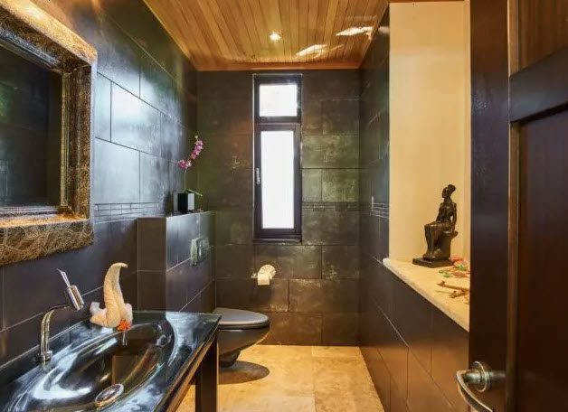 buyDRproperty Modern bathroom in Beautiful Villa WINDWARD at Sea Horse Ranch with dark tile and wooden ceiling Sosua Real Estate