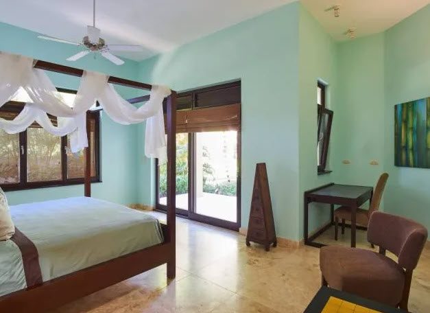 buyDRproperty Bedroom in Beautiful Villa WINDWARD in Sea Horse Ranch with four-poster bed and desk. Sosua Real Estate