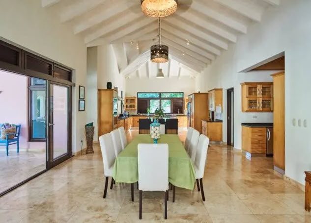 buyDRproperty Dining room in Beautiful Villa WINDWARD in Sea Horse Ranch with a long dining table and light-colored walls. Sosua Real Estate