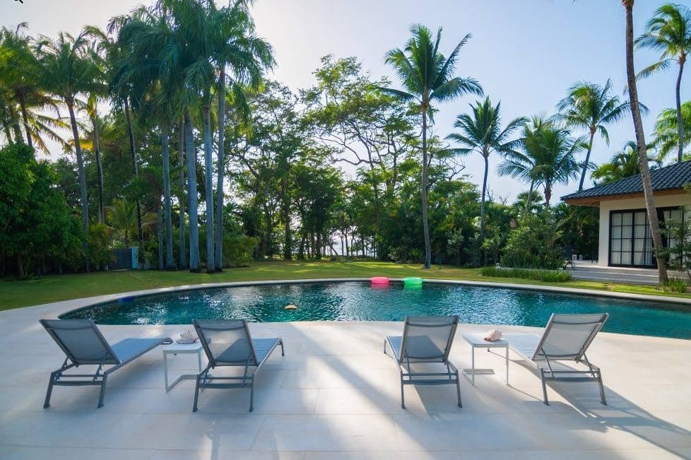 buyDRproperty Luxury pool at Stunning Villa SUNSET in Sea Horse Ranch, with lounge chairs and tropical surroundings. Sosua Real Estate