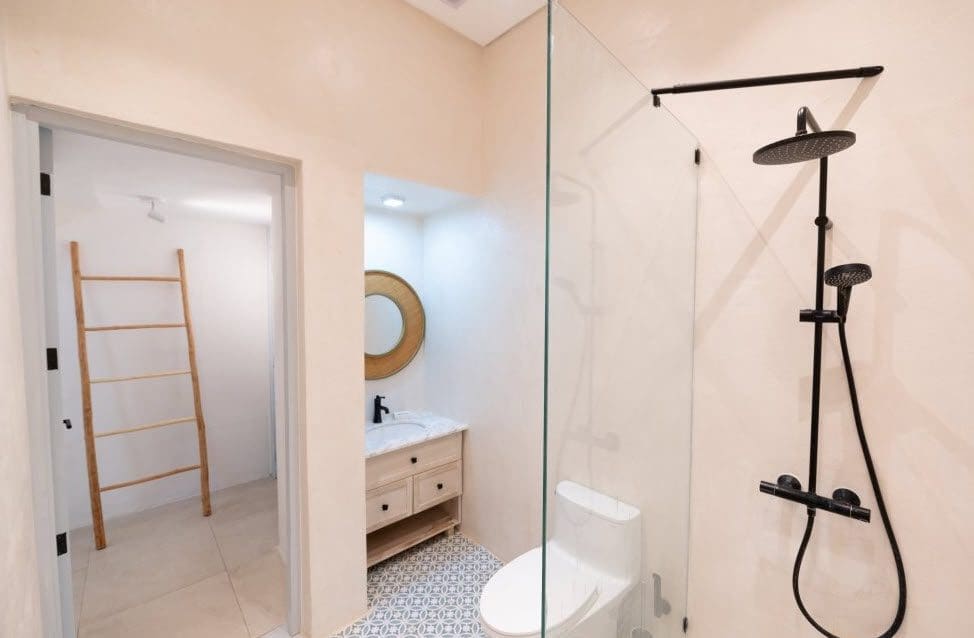 buyDRproperty Modern bathroom in a Stunning Villa SUNSET with black fixtures and glass shower Sosua Real Estate