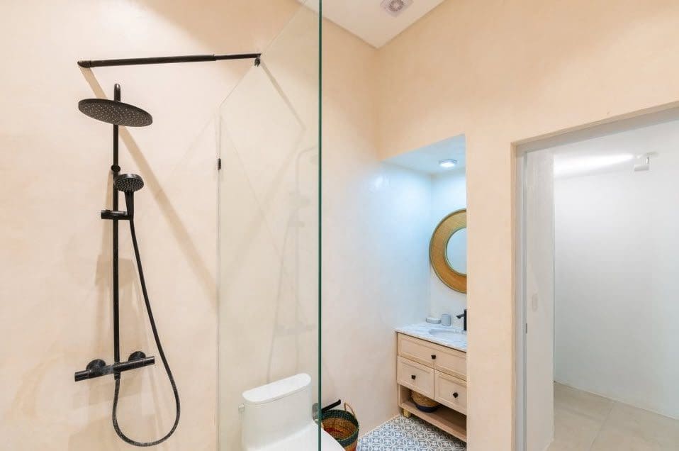 buyDRproperty Modern bathroom with black shower fixtures and glass shower screen in a Stunning Villa SUNSET. Sosua Real Estate