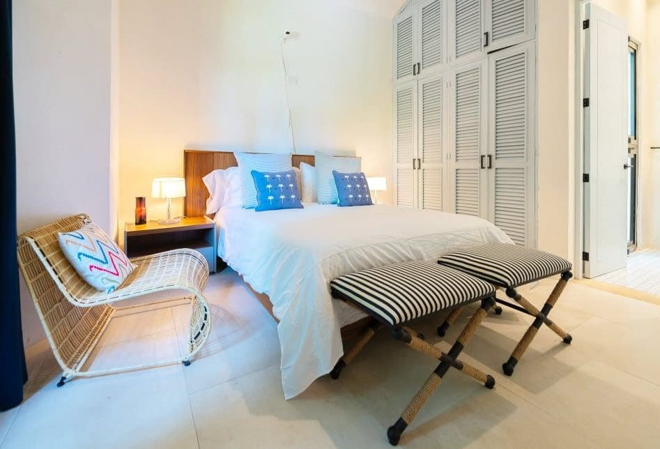 buyDRproperty Bedroom in Stunning Villa SUNSET for sale, featuring a bed, chair, and wardrobe. Sosua Real Estate
