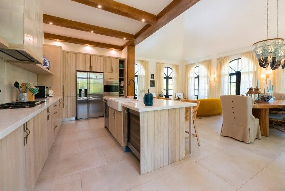 buyDRproperty Spacious kitchen in a Stunning Villa SUNSET with light wood cabinets and island. Sosua Real Estate