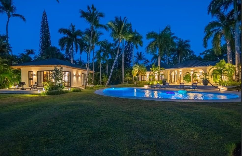 buyDRproperty Stunning Villa SUNSET with pool and palm trees at dusk in Sea Horse Ranch Sosua Real Estate